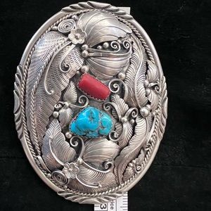 Custom sterling silver belt buckle with corral and turquoise stones.